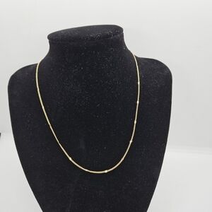 delicate gold tone chain necklace with flat stations